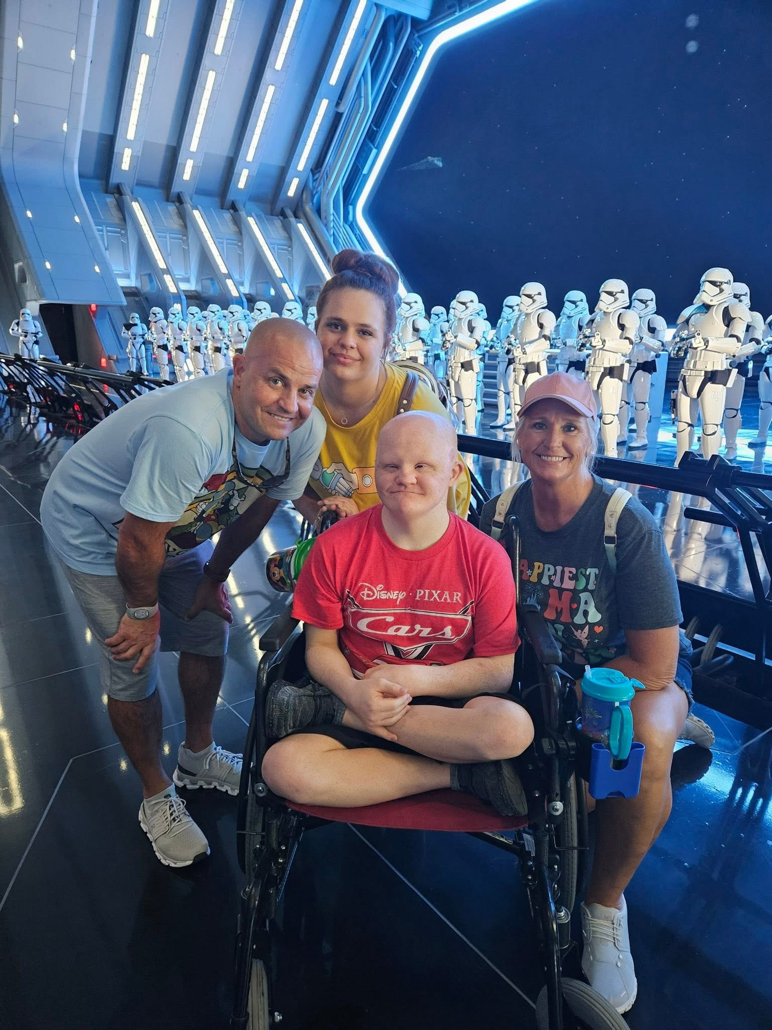 Four family members posing together in the First Order hangar at Star Wars: Rise of the Resistance, with stormtroopers in the background