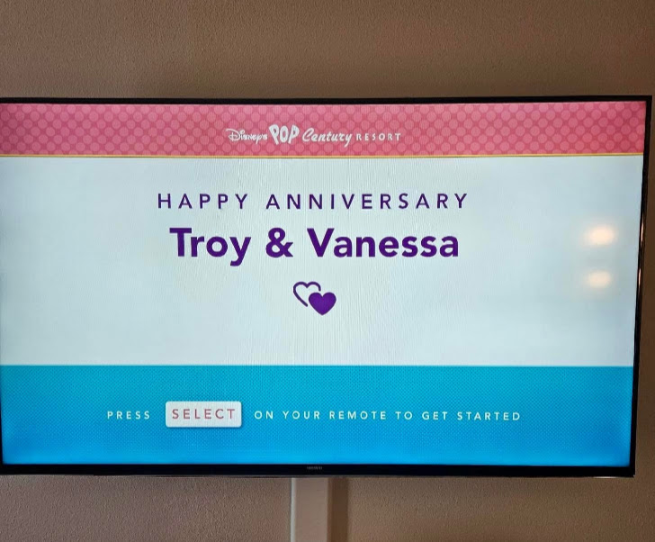 Disney’s Pop Century Resort television displaying a Happy Anniversary message for Troy and Vanessa.