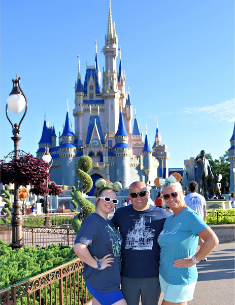 Vanessa, Troy and Arianna together in front of Cinderella Castle at Walt Disney World.